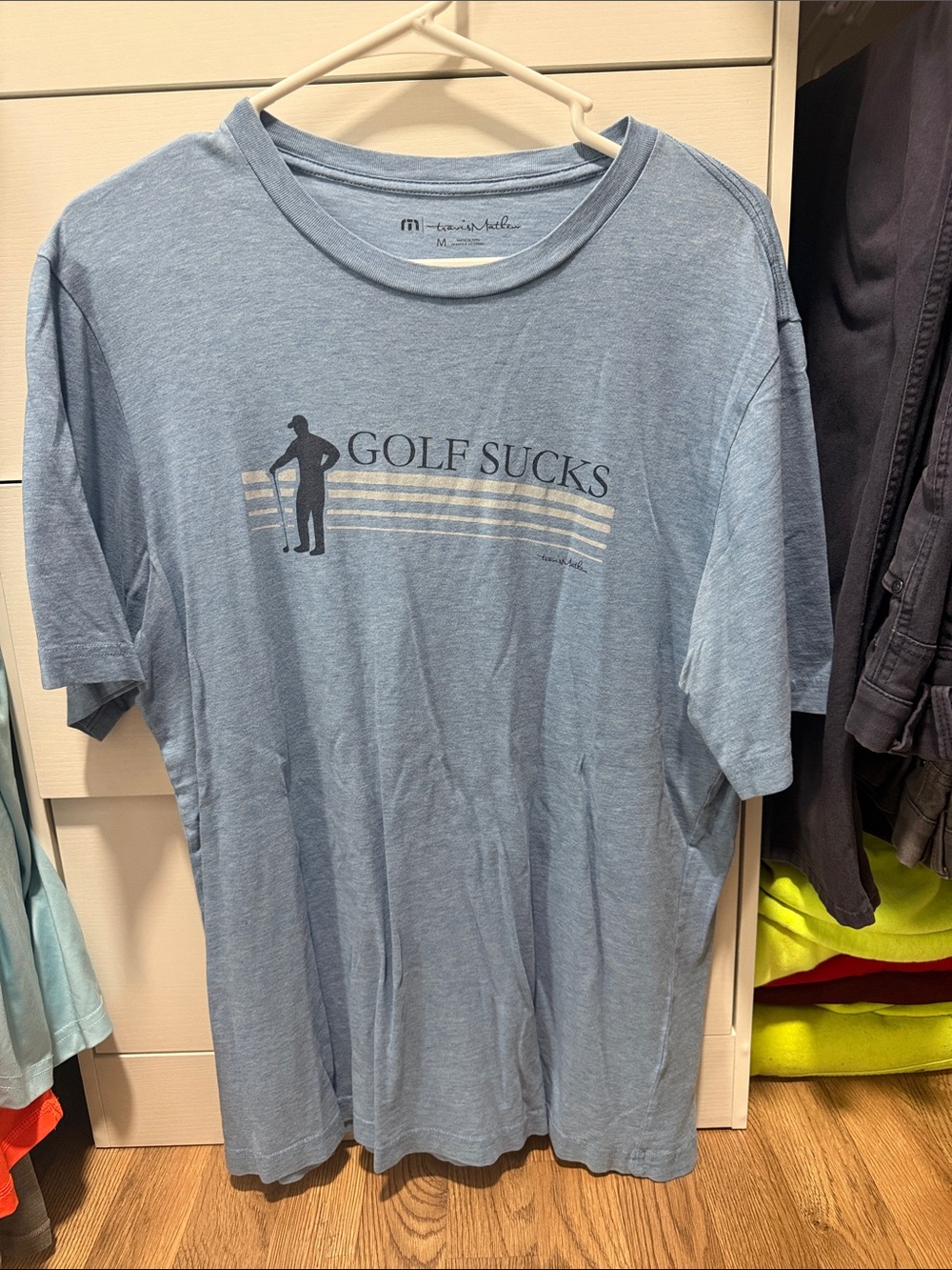 Travis Mathew Light Blue 'Golf Sucks' Graphic Tee